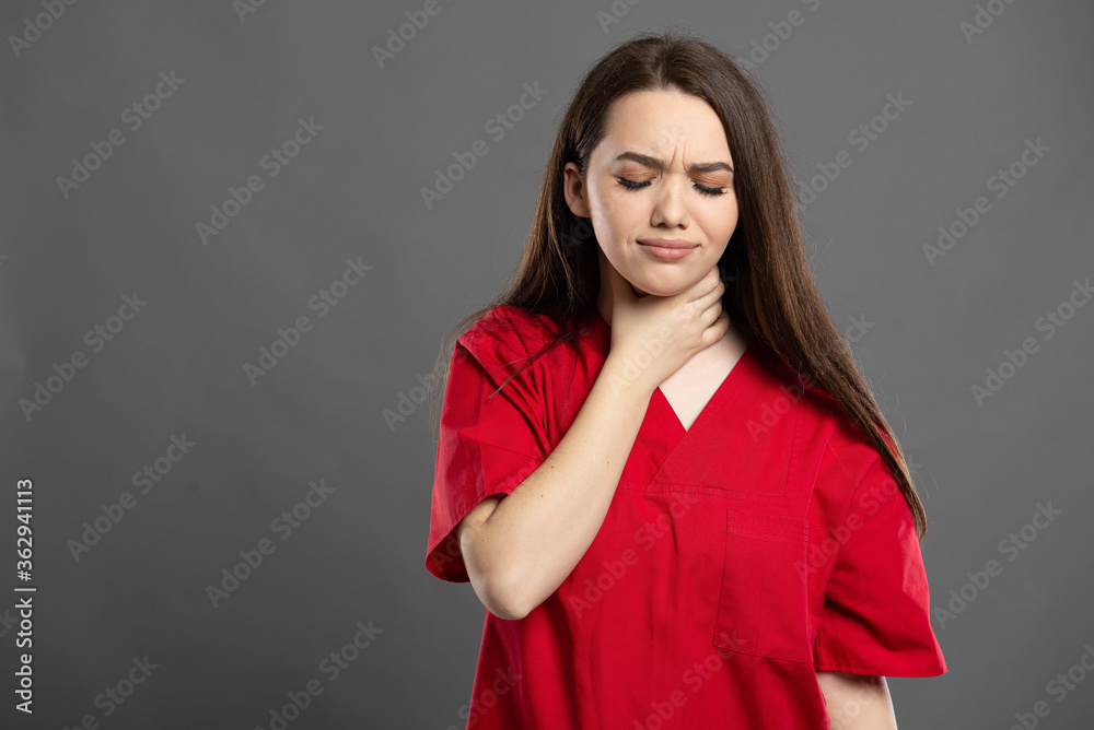 Fototapeta premium Portrait of a nurse having throat pain from virus