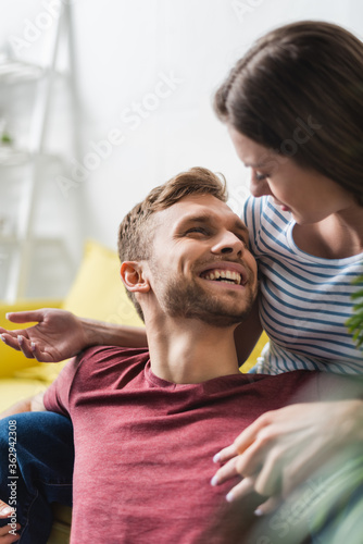 happy emotional young couple hugging at home