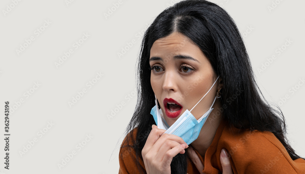 Arab Woman with protective face mask off and breathing fresh air. Concept of taking off the mask. coronavirus over concept. Arab Woman with protective face mask off and breathing fresh air. Concept of taking off the mask. coronavirus over concept.