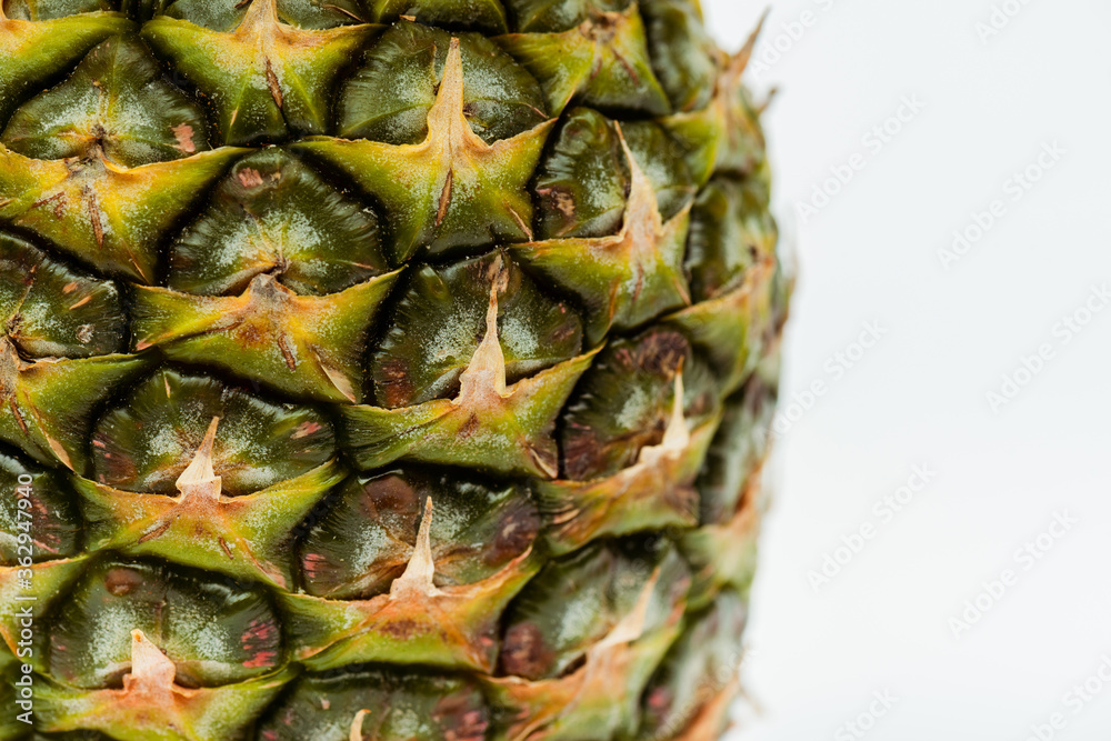 close up view of pineapple with brown textured peel isolated on white close up view of pineapple with brown textured peel isolated on white