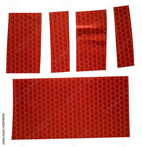 pieces of red glossy cloth gaffer tape stickers isolated on white background, red reflector stickers or snips, macro photo
 photo