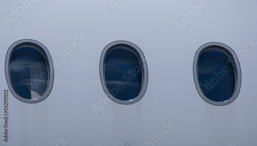 The porthole of the plane. Three windows. 