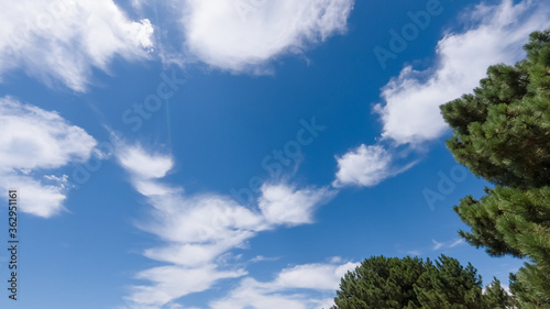 white cumulus clouds on a blue sky, bright sunny day, beautiful natural landscape