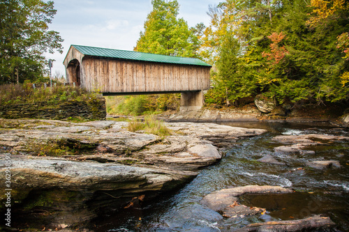 The Montgomery Covered Bridge, also known as the Lower Covered Bridge is a wooden covered bridge that carries Montgomery Road across the North Branch of the Lamoille River in Waterville, Vermont photo