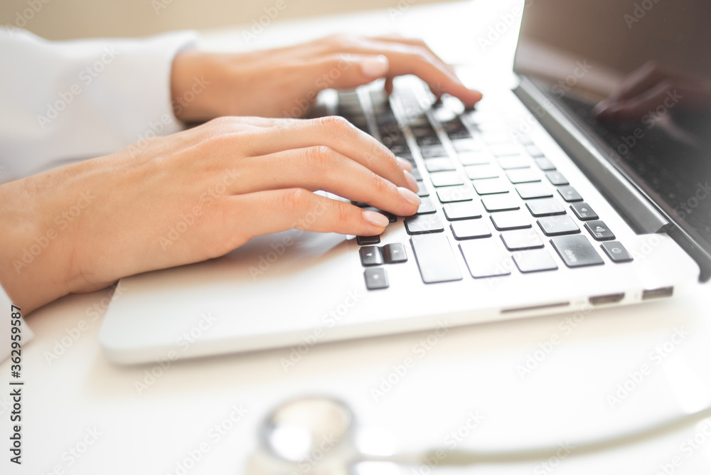doctor is typing on a laptop keyboard. online doctor consultation doctor is typing on a laptop keyboard. online doctor consultation