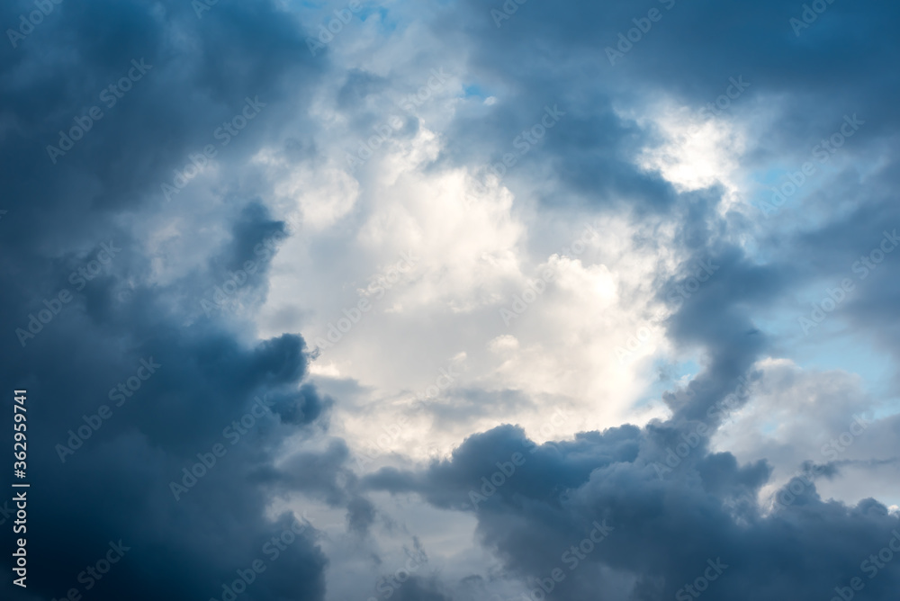 Beautiful dramatic clouds after the storm creating a natural frame around light area of the sky