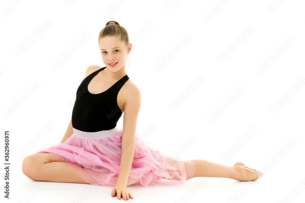 Blonde Girl in Stylish Tulle Dress Sitting on the Floor on her Knees. Blonde Girl in Stylish Tulle Dress Sitting on the Floor on her Knees.