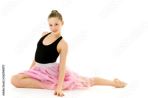 Blonde Girl in Stylish Tulle Dress Sitting on the Floor on her Knees.