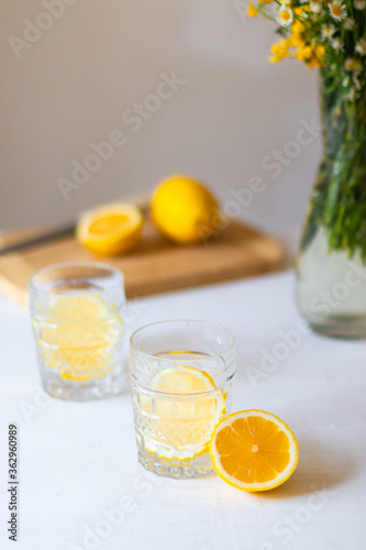 Glass with lemonade or mojito cocktail on white background for summer party. Summer drinks with ice