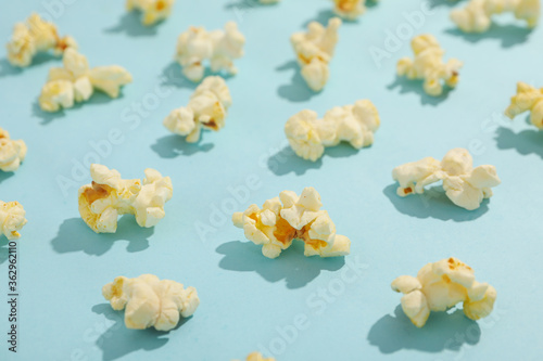Flat lay with popcorn on blue background. Food for cinema