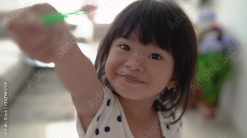 Little Girl Playing Ice Cream At Home photo