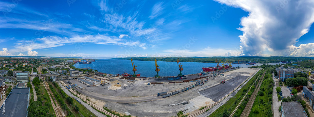 Amazing Aerial panorama from the drone to cargo port and a large ship loading grain for export in the harbor. Water transport