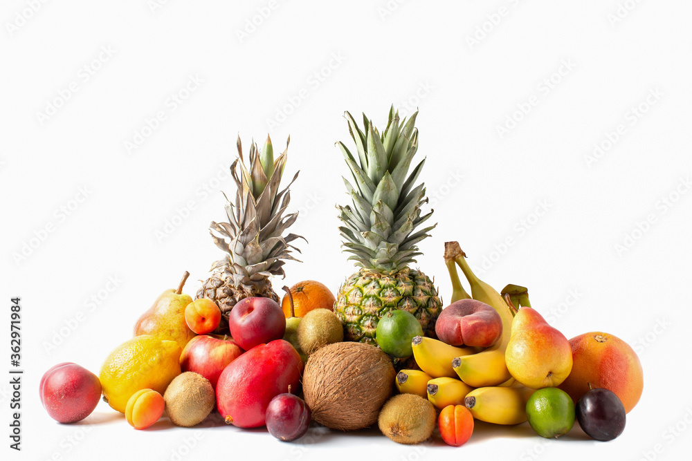 Tropical fruits assortment isolated on white background. Pineapples, coconut, bananas, mango, apples, kiwi, lime, lemon, pear, apricots, peaches and plum. Tropical fruits assortment isolated on white background. Pineapples, coconut, bananas, mango, apples, kiwi, lime, lemon, pear, apricots, peaches and plum.