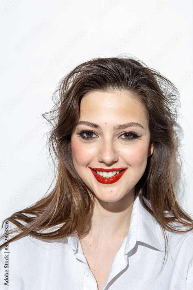 Beauty portrait of a girl with makeup with red lips