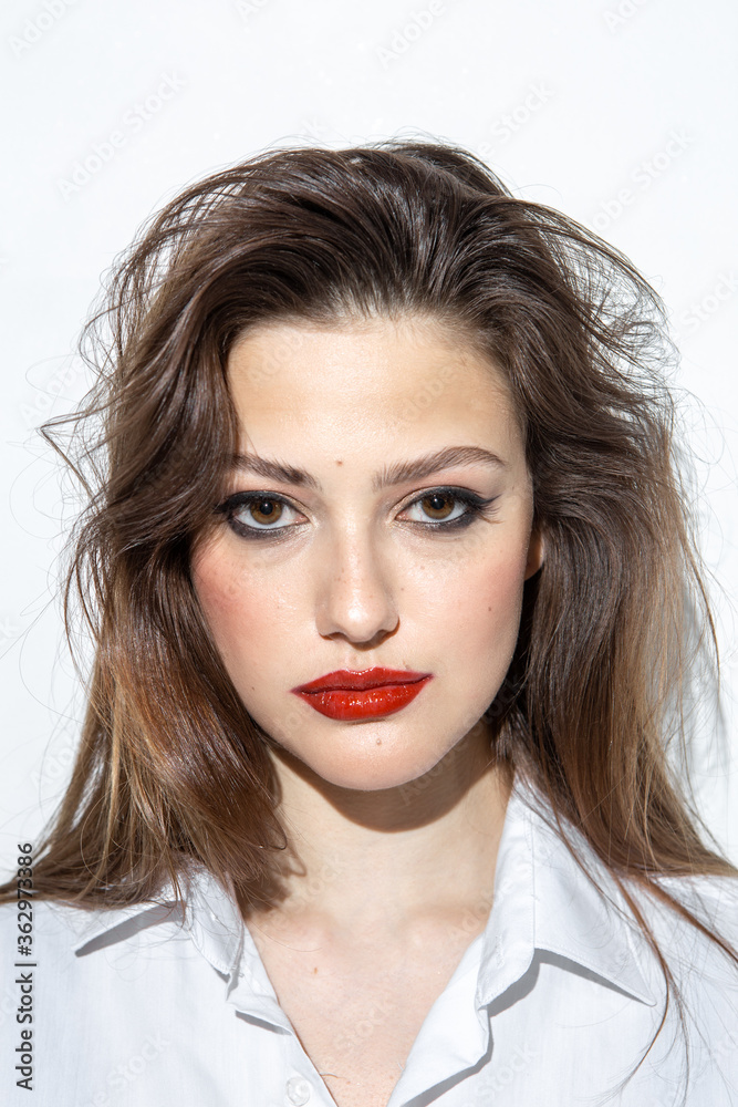 Beauty portrait of a girl with makeup with red lips Beauty portrait of a girl with makeup with red lips