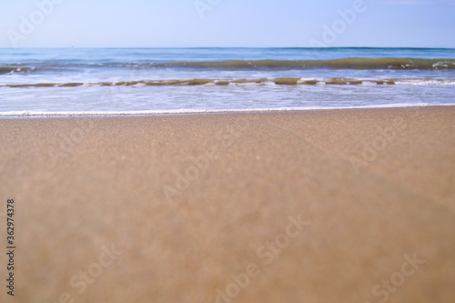 waves with foam on tropical sandy beach. copy space