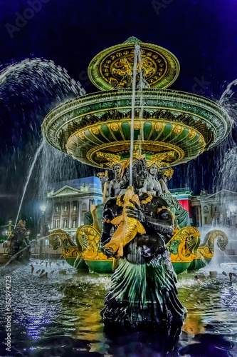 Fontaines de la Concorde (designed by Jacques Ignace Hittorff, 1840) at night on Place Concorde in Paris, France. North fountain commemorates navigation and commerce on rivers of France. photo