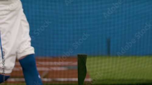Swinging through it. Practicing the perfect swing in a batting cage. Practice makes perfect. Shot in slow-motion and in 4k. 