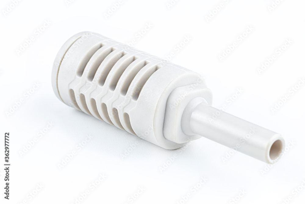 Macro shoot of a white pneumatic air silencer mounted on a quick coupling for pneumatic installations, isolated on a white background with a clipping path. Macro shoot of a white pneumatic air silencer mounted on a quick coupling for pneumatic installations, isolated on a white background with a clipping path.