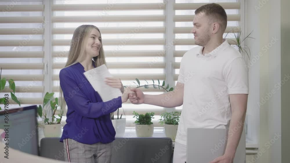 Confident male doctor closing laptop and shaking hand of satisfied Caucasian woman. Supply company and hospital signing deal on cooperation. Medical teamwork, health care concept. Confident male doctor closing laptop and shaking hand of satisfied Caucasian woman. Supply company and hospital signing deal on cooperation. Medical teamwork, health care concept.