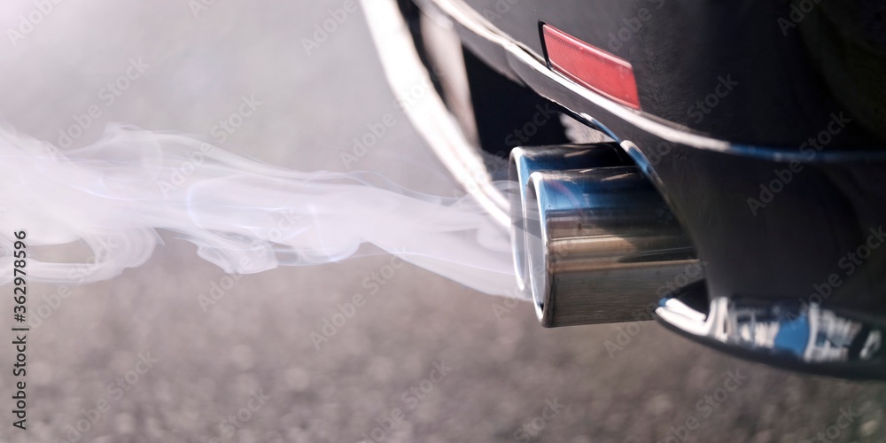 Fototapeta premium Smoky dual exhaust pipes from a starting diesel car.