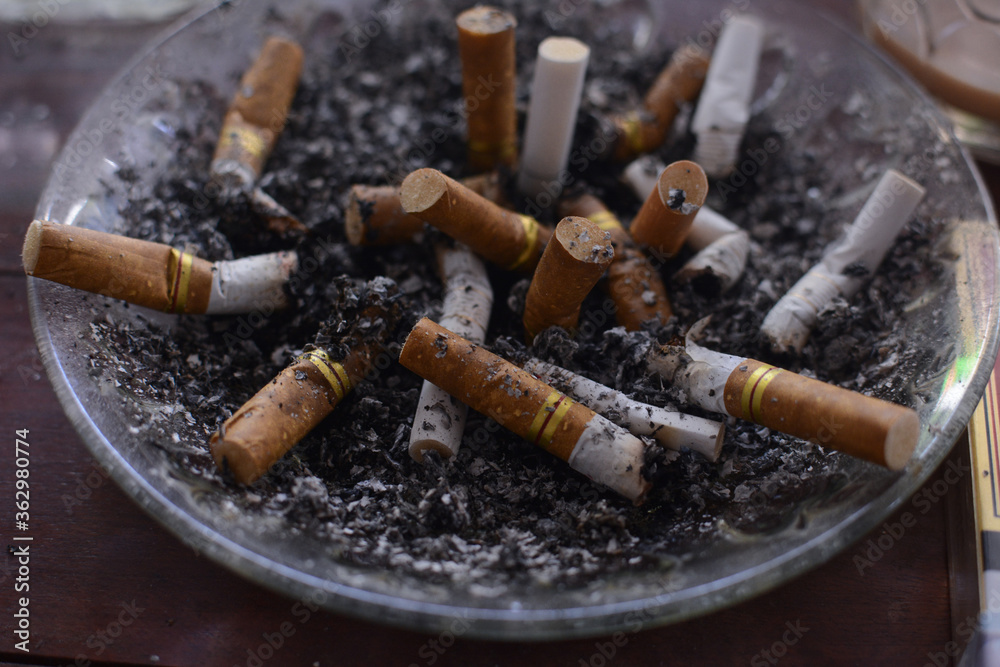 used cigarettes in ashtrays with selective focus used cigarettes in ashtrays with selective focus