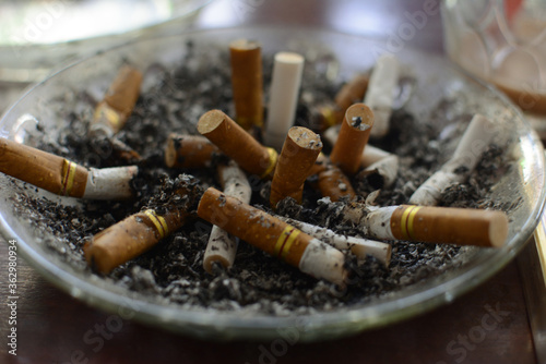 used cigarettes in ashtrays with selective focus