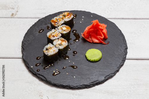 maki roll  with eel on a black slate