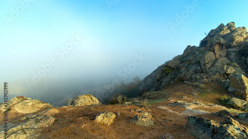 Misty dawn on the from pile of huge stones of rocks in the autumn © watcherfox