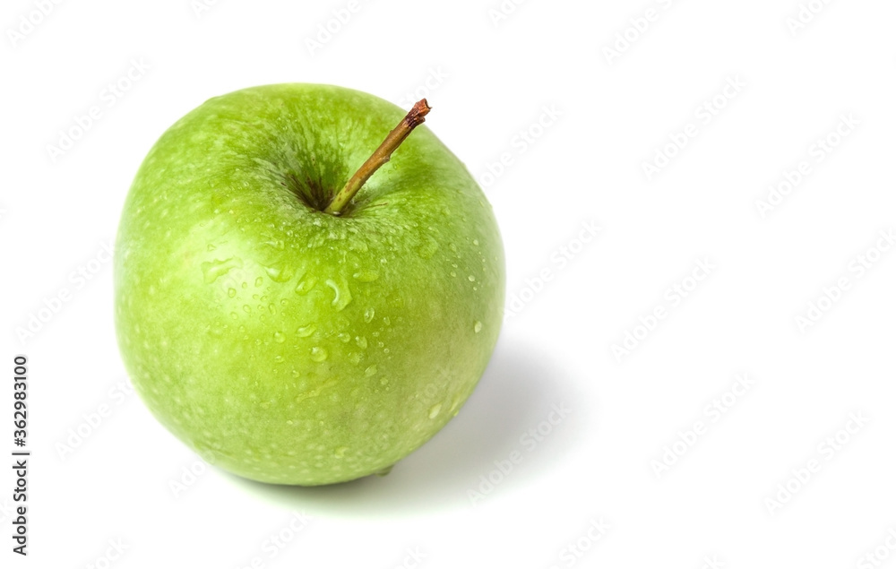 Green apple on a white background. Selective focus. Green apple on a white background. Selective focus.