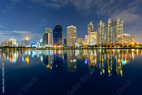 Skyline of Bangkok with reflections in the lake, at the twilight, Thailand