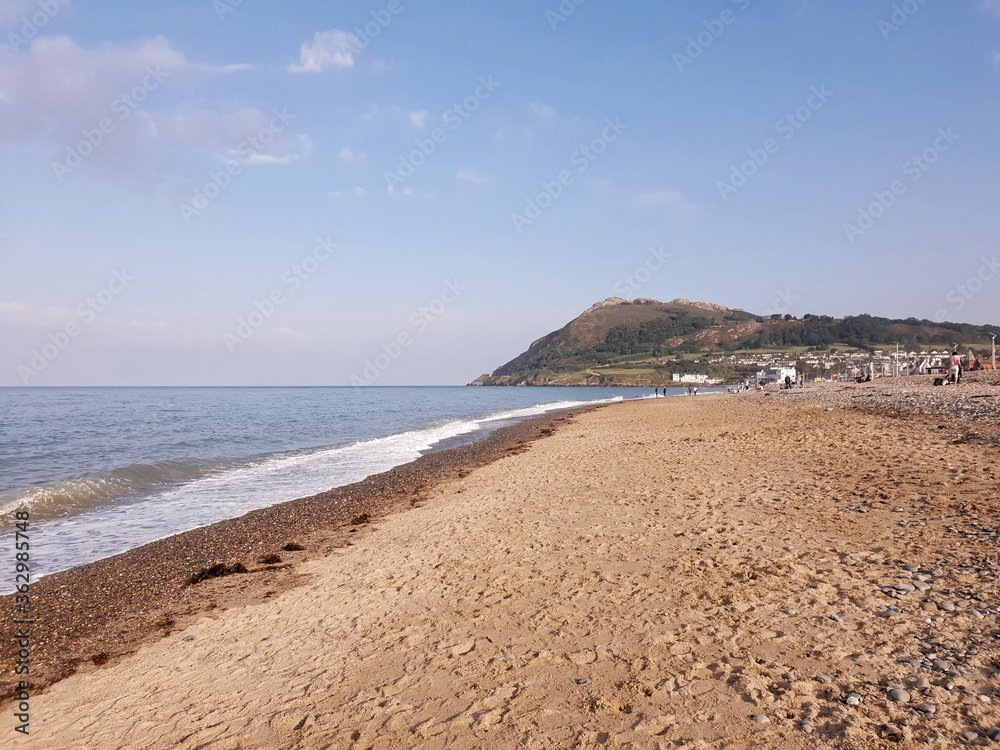 The Irish Sea seascape with the Bray Head mountain on the horizon. Warm and sunny day on the beach. The Irish Sea seascape with the Bray Head mountain on the horizon. Warm and sunny day on the beach.