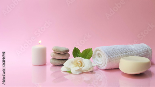 Spa setting and Spa background composition with white gardenia flower on pink background. Banner