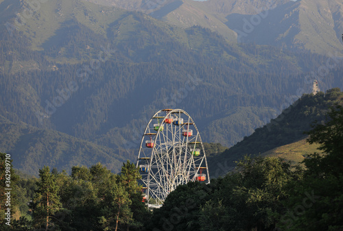 ferris wheel on a background of mountains