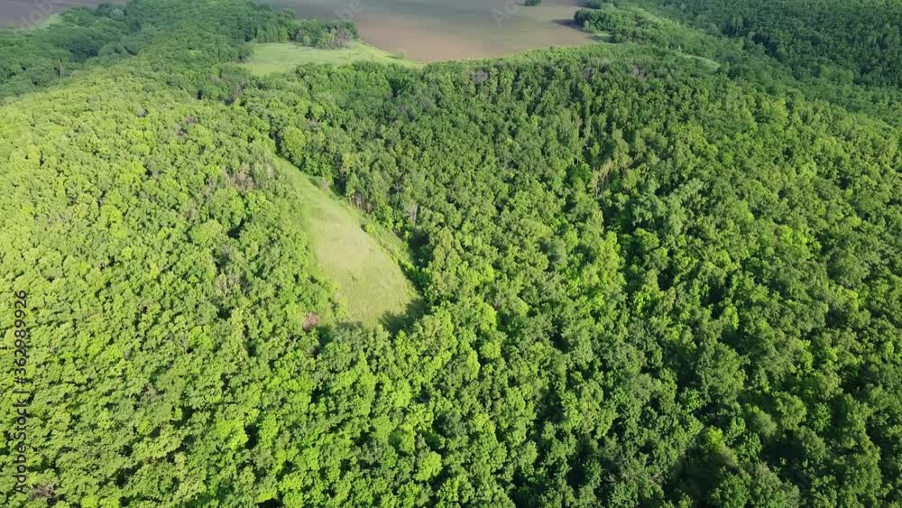 aerial view flying over a beautiful landscape. farm fields and green trees from above aerial view flying over a beautiful landscape. farm fields and green trees from above