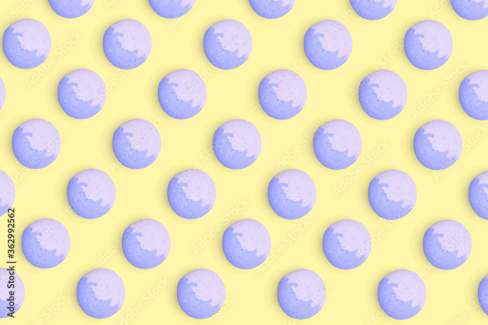 Macaroons pattern on colored background, a pattern of colorful french cookies macarons. Blue french cookies macarons on yellow background. Gift for congratulations. Macaroons pattern on colored background, a pattern of colorful french cookies macarons. Blue french cookies macarons on yellow background. Gift for congratulations.