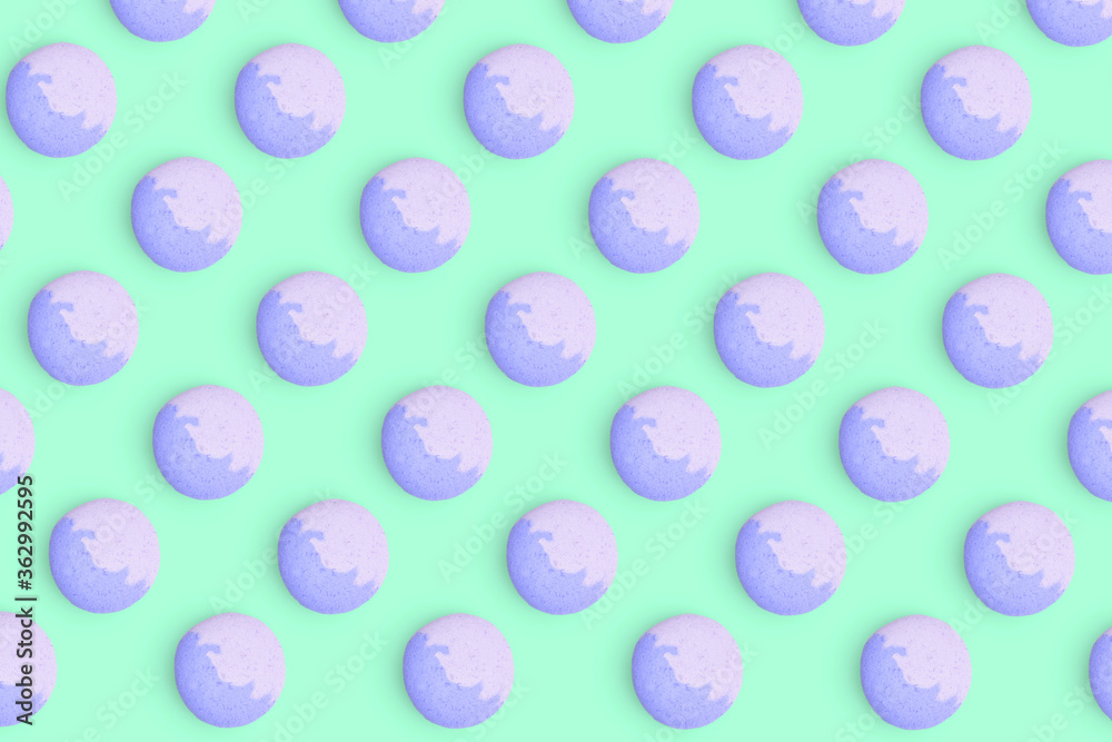 Macaroons pattern on colored background, a pattern of colorful french cookies macarons. Blue french cookies macarons on green background. Gift for congratulations. Macaroons pattern on colored background, a pattern of colorful french cookies macarons. Blue french cookies macarons on green background. Gift for congratulations.