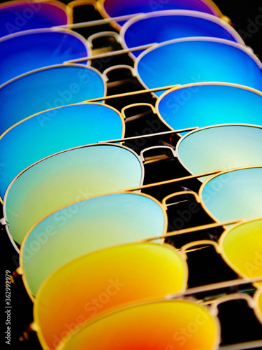 Obraz na płótnie Sunglasses with colorful lenses on black background w salonie