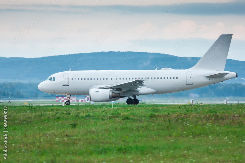 White passenger jet plane taxiing on the taxiway White passenger jet plane taxiing on the taxiway