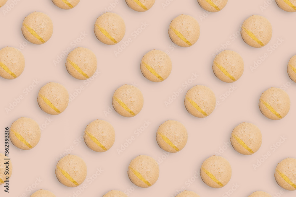 Macaroons pattern on colored background, a pattern of colorful french cookies macarons. Beige french cookies macarons on orange background. Gift for congratulations. Macaroons pattern on colored background, a pattern of colorful french cookies macarons. Beige french cookies macarons on orange background. Gift for congratulations.