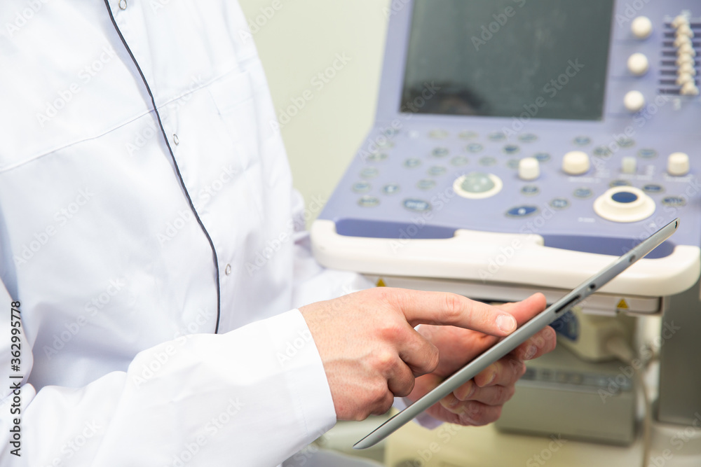 Skillful sonographer using ultrasound machine at work Skillful sonographer using ultrasound machine at work