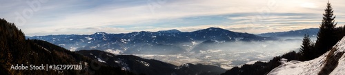 clear blue panorama in the austrian alps with clouds and fog on a cold winter day © woitzel