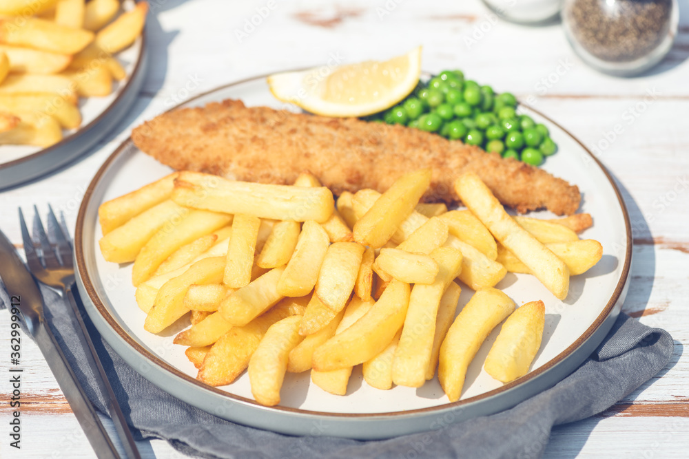 Traditional British Food such as Fish and Chips with green peas served in the Pub or Restaurant Traditional British Food such as Fish and Chips with green peas served in the Pub or Restaurant