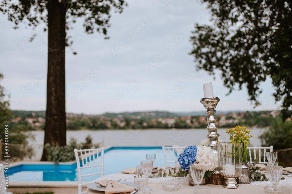 Fototapeta premium Beautiful pastel floral decoration for outdoor celebration by the river