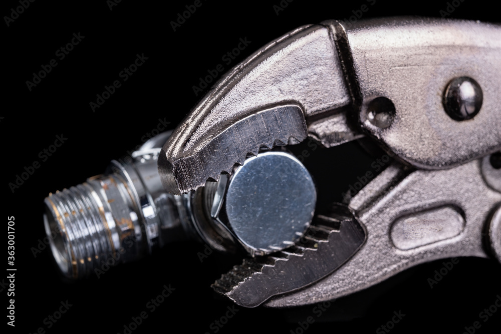 Silver plumbing wrench and chrome pipe. Plumbing accessories for minor repairs at home. Silver plumbing wrench and chrome pipe. Plumbing accessories for minor repairs at home.
