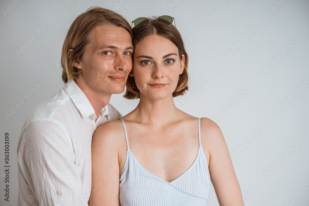 attractive couple embracing each other over white background