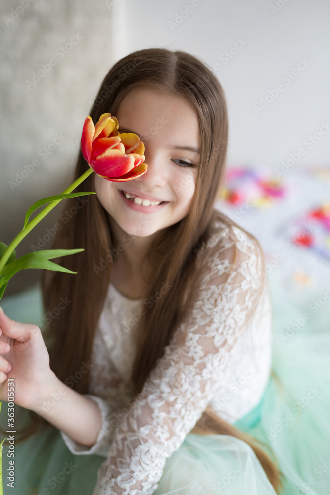 Happy girl holding a large bouquet tulips in his hands
