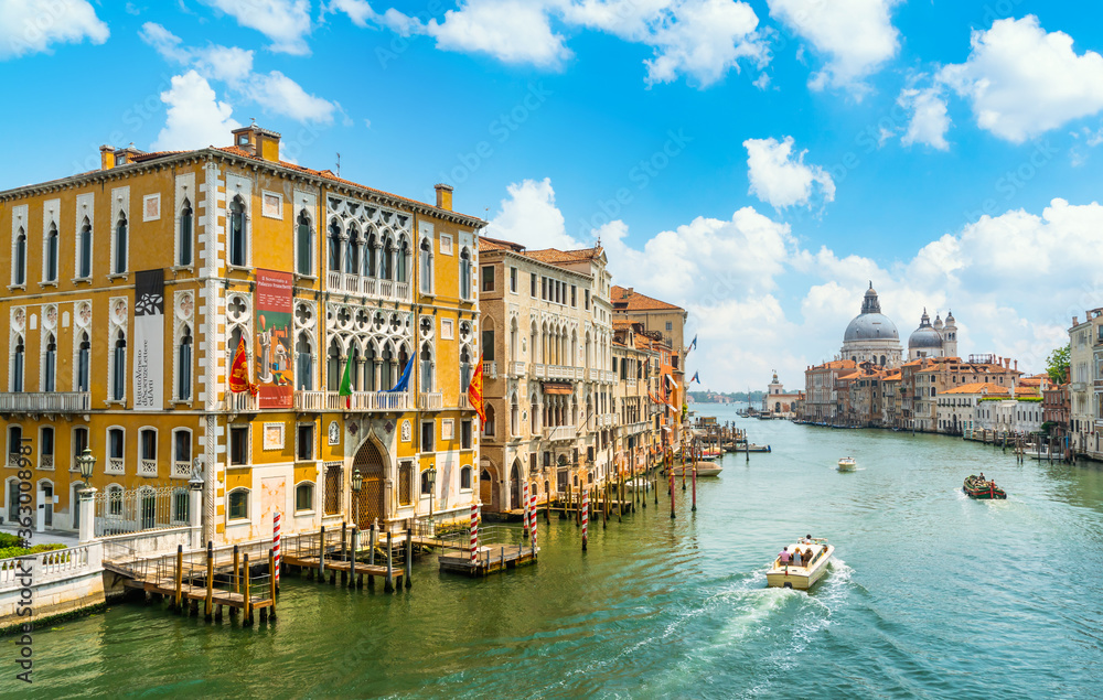 Venice, Italy - june 29th 2020 - The quiet Grand Canal and the Basilica di Santa Maria della Salute seen from the Ponte dell Accademia bridge on a sunny Corona day in summer