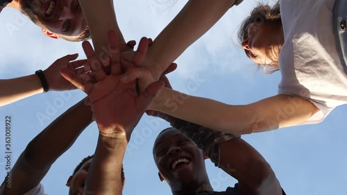 Crossed hands of people of different colors, multi-racial group of people, support and solidarity of the BLM movement against racism, black lives matter. Interrasial group of students photo