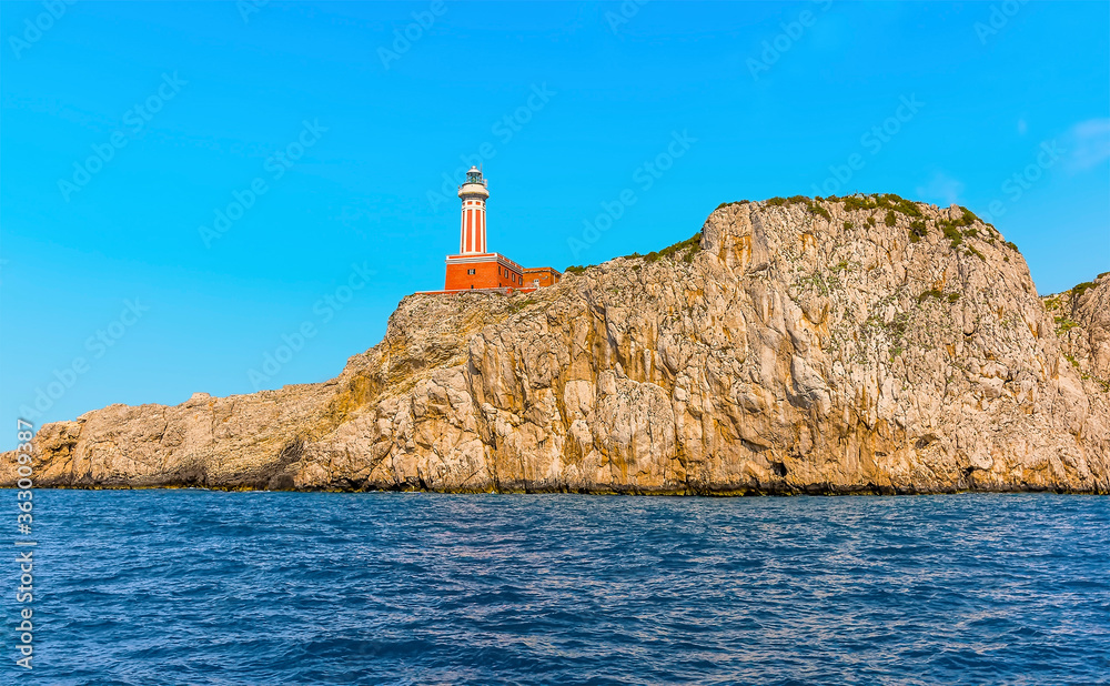 The lighthouse at Punta Carena stands proud on the rocks on the south west side of the island of Capri, Italy